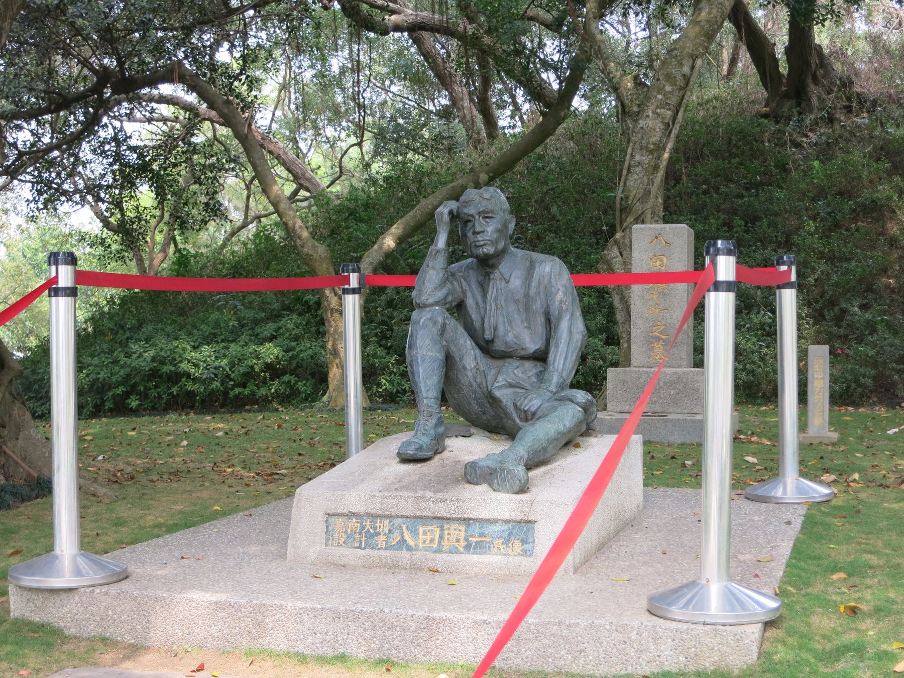 The Yoichi Hatta statue at Wushantou, shown seated in work clothes