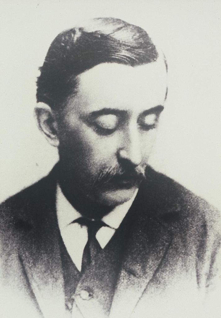 Black-and-white half-length portrait of Lafcadio Hearn in 1889